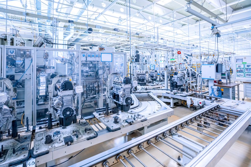 NX-ERA PLC controlling robotic arm in automotive manufacturing plant